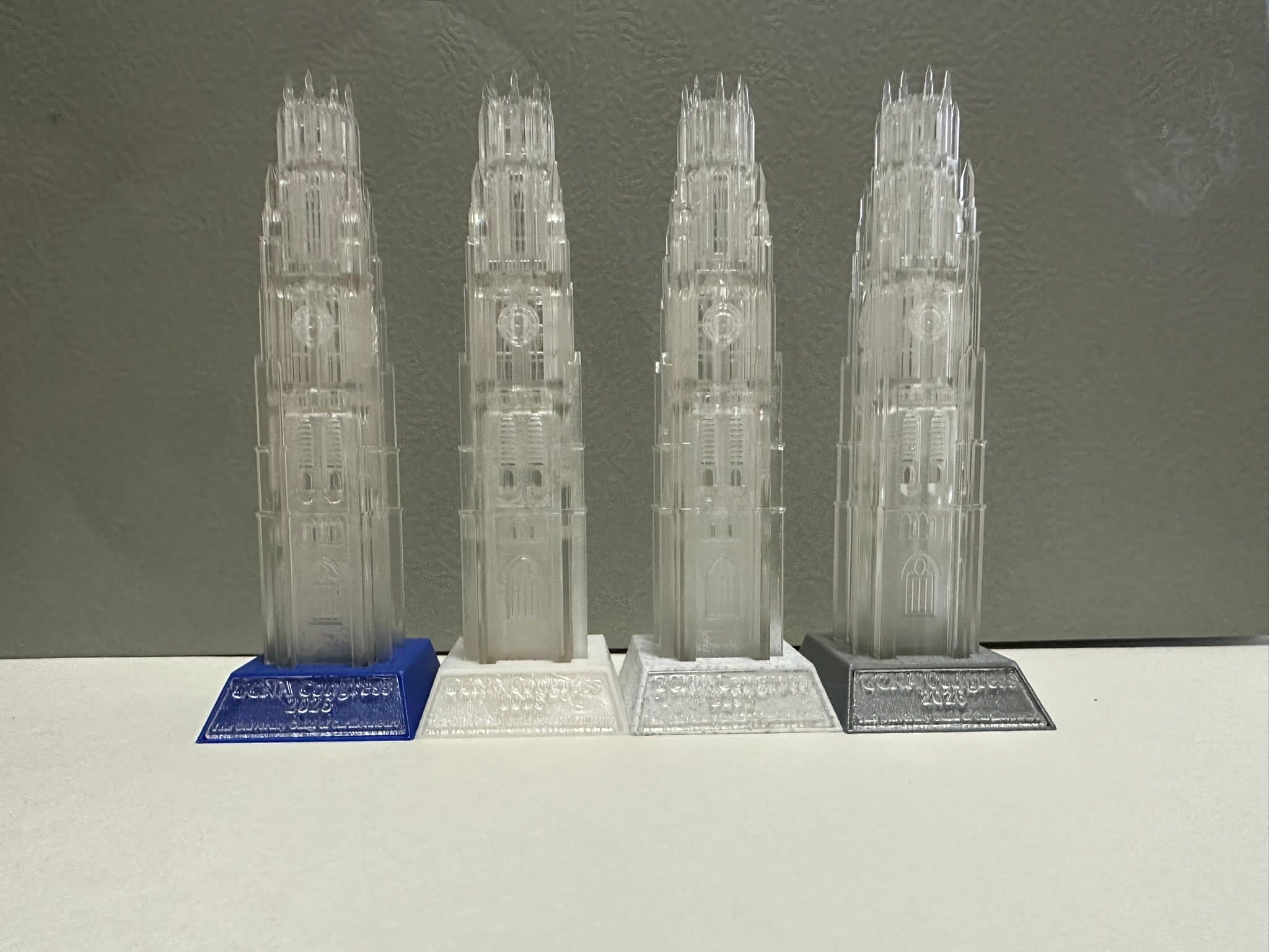 Four finished clear Harkness Tower prototypes with different bases