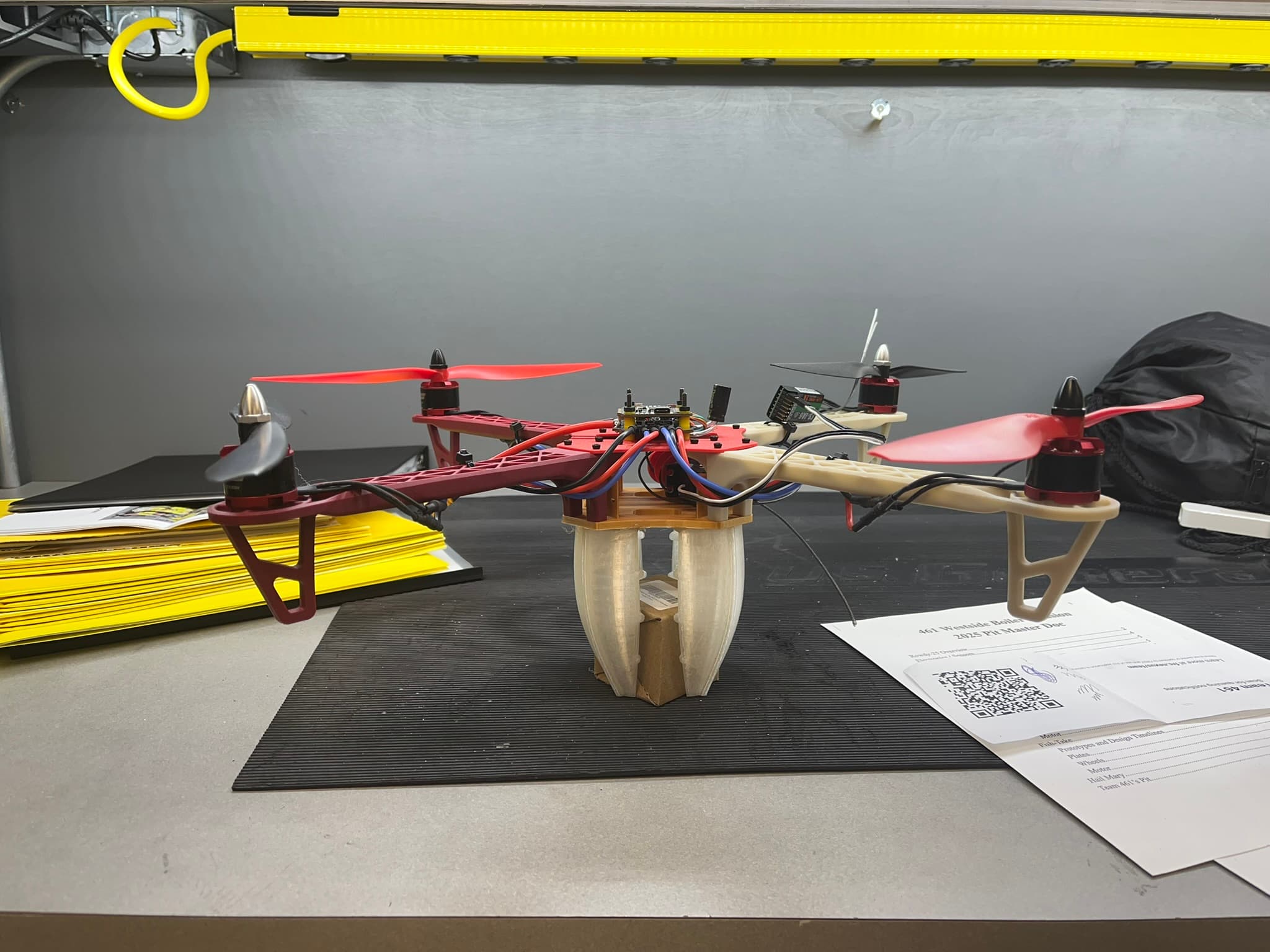 Assembled Nylon-CF quadcopter with exposed flight electronics and a central gripper